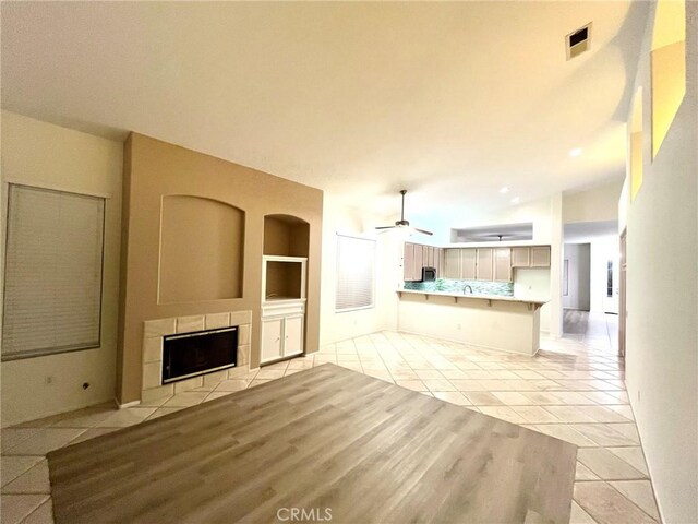 22810 Mountain Ash Cir, Corona, CA 92883 - unfurnished living room featuring a fireplace, light tile patterned flooring, a ceiling fan, and built in features