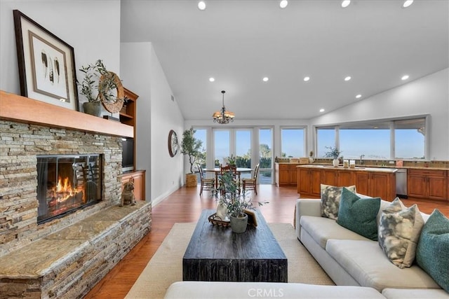 12 Bowie Rd, Rolling Hills, CA 90274 - living room featuring recessed lighting, high vaulted ceiling, a chandelier, light wood-style flooring, and a fireplace