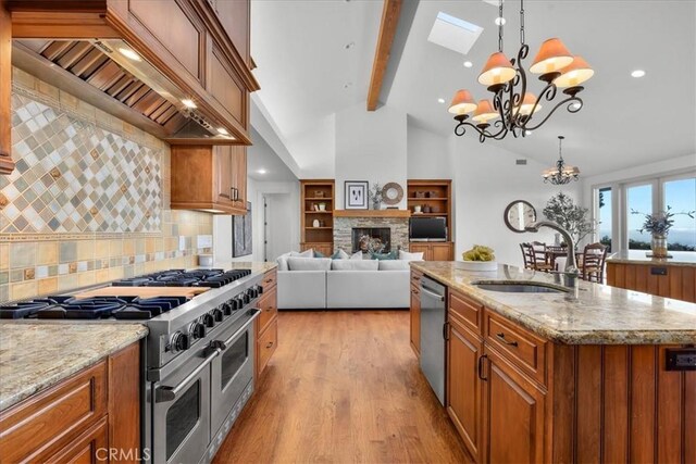 12 Bowie Rd, Rolling Hills, CA 90274 - kitchen with stainless steel appliances, custom range hood, brown cabinetry, a chandelier, and beamed ceiling