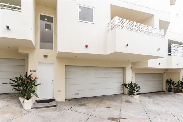 1020 Hilldale Ave, West Hollywood, CA 90069 - rear view of house featuring an attached garage and stucco siding