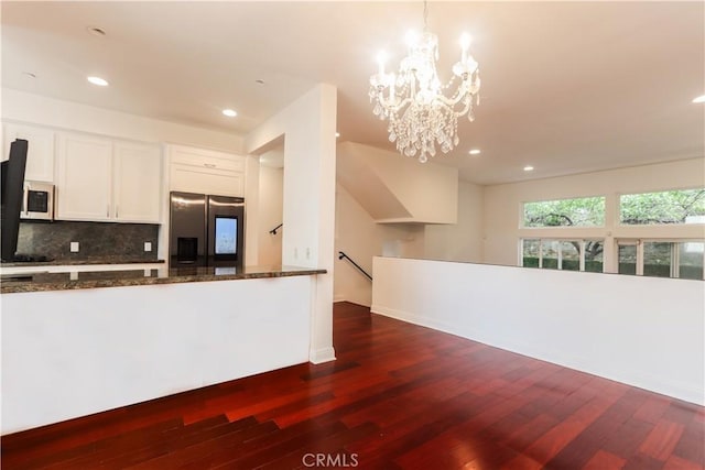 1020 Hilldale Ave, West Hollywood, CA 90069 - kitchen featuring dark stone counters, stainless steel fridge with ice dispenser, white microwave, and dark wood-type flooring