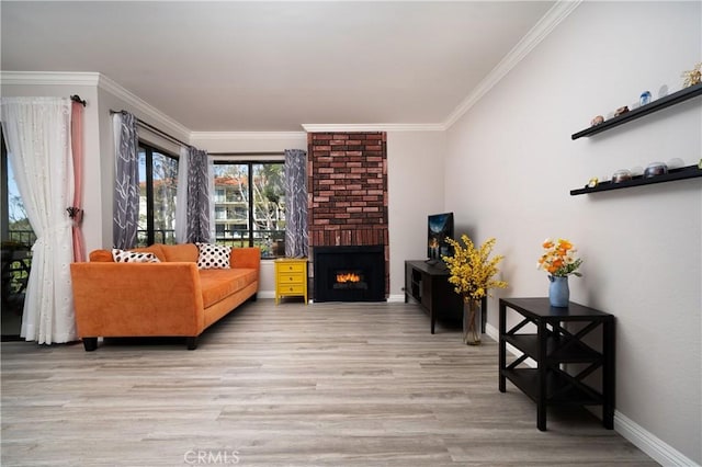 living room featuring crown molding, baseboards, a brick fireplace, and light wood-style flooring