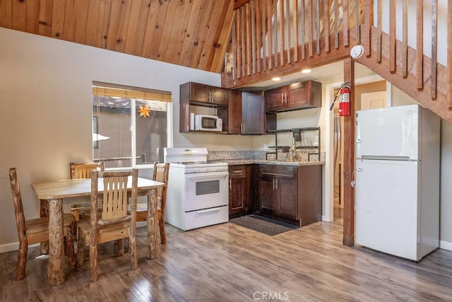 550 Pine Ln, Sugarloaf, CA 92386 - kitchen featuring baseboards, light wood-type flooring, dark brown cabinets, and white appliances