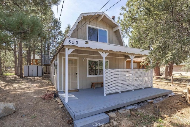 550 Pine Ln, Sugarloaf, CA 92386 - rear view of property with fence, a deck, and an outbuilding