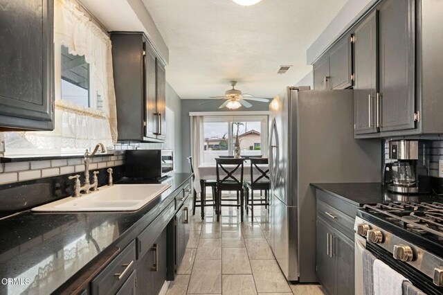309 W Rosa St, Oxnard, CA 93033 - kitchen featuring appliances with stainless steel finishes, backsplash, a sink, visible vents, and a ceiling fan