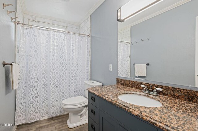 309 W Rosa St, Oxnard, CA 93033 - bathroom with wood finished floors, toilet, vanity, curtained shower, and crown molding