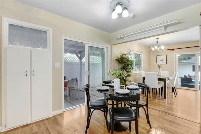 927 Alta Loma Dr, Corona, CA 92882 - dining area with plenty of natural light, light wood finished floors, and a chandelier