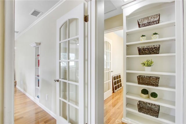 927 Alta Loma Dr, Corona, CA 92882 - hallway featuring wood finished floors, built in shelves, and crown molding