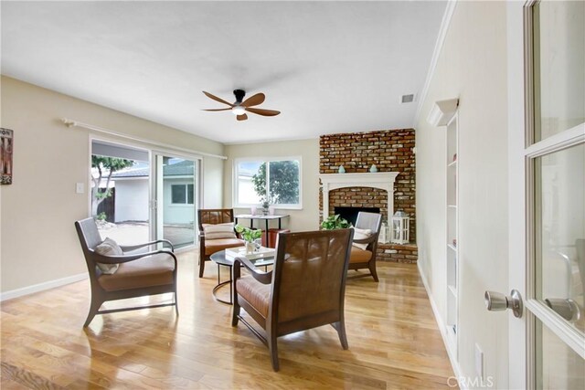927 Alta Loma Dr, Corona, CA 92882 - living area featuring plenty of natural light, ceiling fan, light wood-style floors, and a brick fireplace