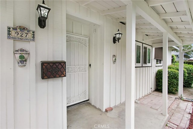 927 Alta Loma Dr, Corona, CA 92882 - doorway to property with board and batten siding and covered porch