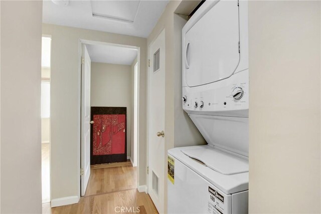 927 Alta Loma Dr, Corona, CA 92882 - laundry room with stacked washer / dryer and light wood-type flooring