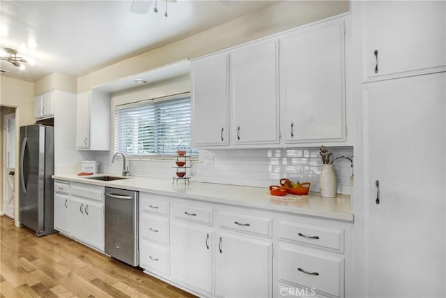 927 Alta Loma Dr, Corona, CA 92882 - kitchen featuring appliances with stainless steel finishes, decorative backsplash, white cabinetry, light countertops, and light wood finished floors