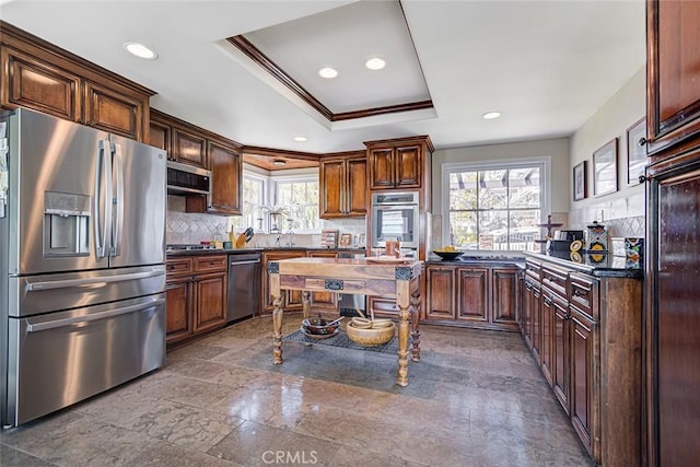 812 8th St, Manhattan Beach, CA 90266 - kitchen featuring dark countertops, stainless steel appliances, a healthy amount of sunlight, and backsplash