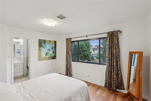 4447 Walnut Ave, Chino, CA 91710 - bedroom with visible vents, ensuite bath, and light wood-style floors