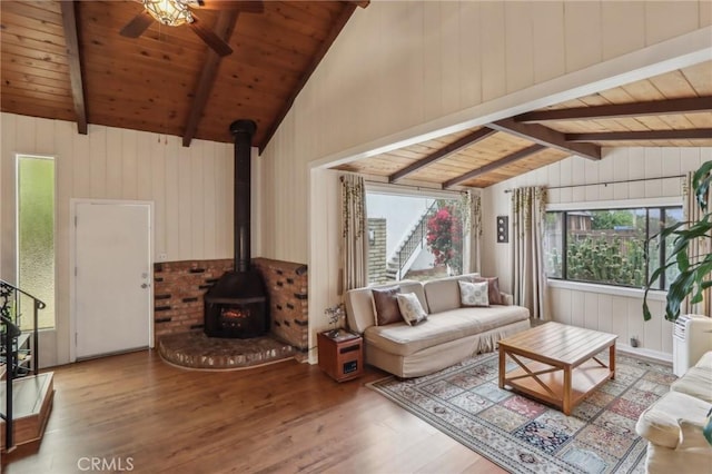 4447 Walnut Ave, Chino, CA 91710 - living area featuring wood finished floors, lofted ceiling with beams, a wood stove, and wooden ceiling