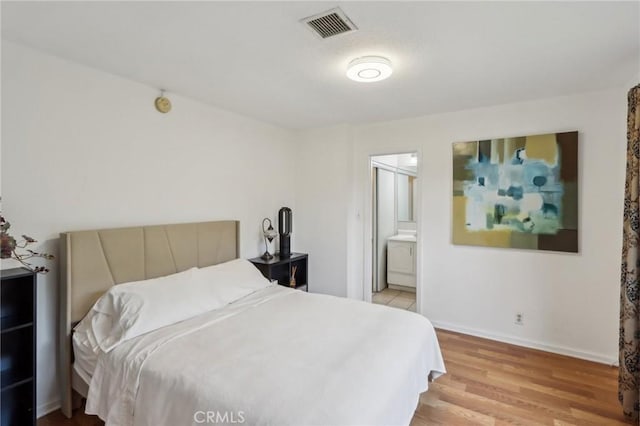 4447 Walnut Ave, Chino, CA 91710 - bedroom featuring light wood finished floors, visible vents, baseboards, and ensuite bath