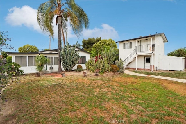 4447 Walnut Ave, Chino, CA 91710 - view of front of property with stucco siding, a front lawn, and stairs