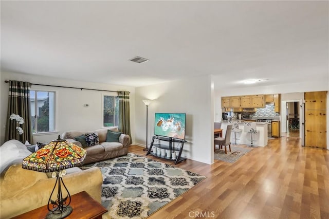 4447 Walnut Ave, Chino, CA 91710 - living room with light wood finished floors and visible vents