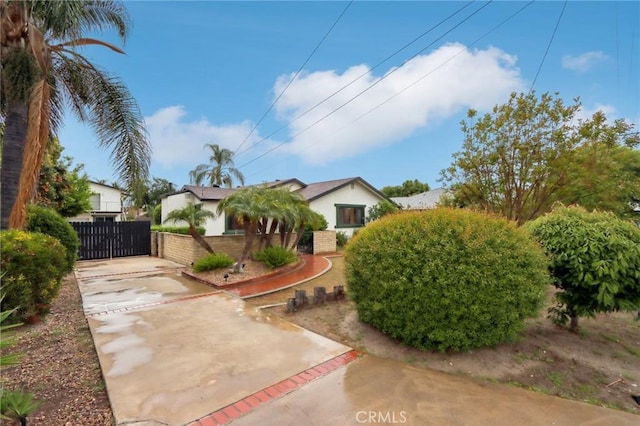 4447 Walnut Ave, Chino, CA 91710 - exterior space featuring stucco siding, a gate, and fence