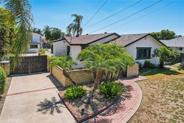 4447 Walnut Ave, Chino, CA 91710 - view of front of home featuring a gate, fence, stucco siding, and cooling unit