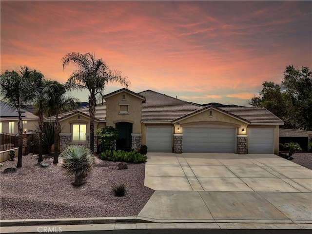 19069 Eldorado Rd, Perris, CA 92570 - view of front of property featuring stucco siding, an attached garage, stone siding, driveway, and a tiled roof
