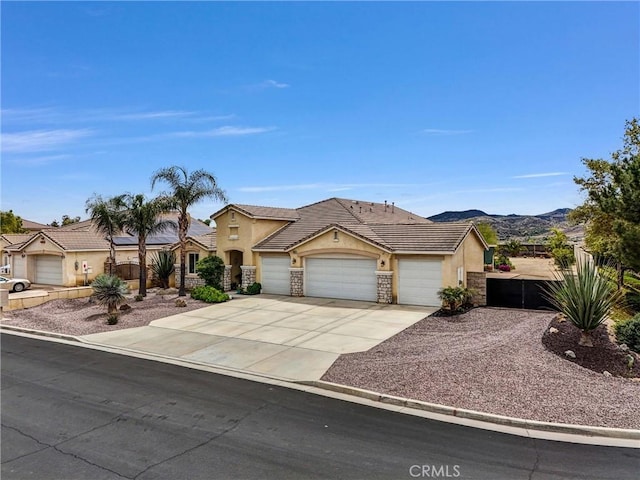 19069 Eldorado Rd, Perris, CA 92570 - view of front of home with stucco siding, an attached garage, stone siding, a tile roof, and driveway