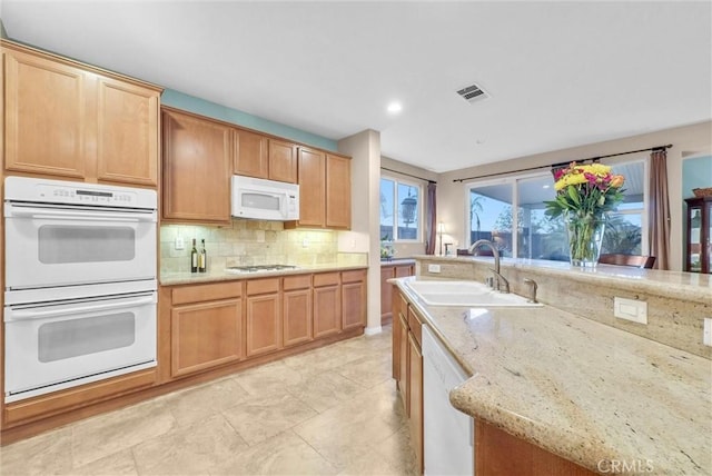 19069 Eldorado Rd, Perris, CA 92570 - kitchen with white appliances, tasteful backsplash, light stone counters, and recessed lighting