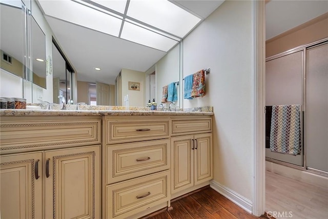 21650 Burbank Blvd Unit 111, Woodland Hills, CA 91367 - bathroom featuring baseboards, wood finished floors, an enclosed shower, and vanity