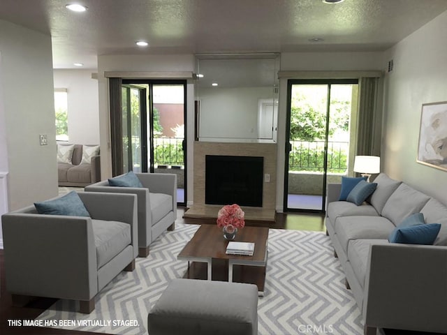21650 Burbank Blvd Unit 111, Woodland Hills, CA 91367 - living area featuring recessed lighting, a textured ceiling, and a fireplace with raised hearth