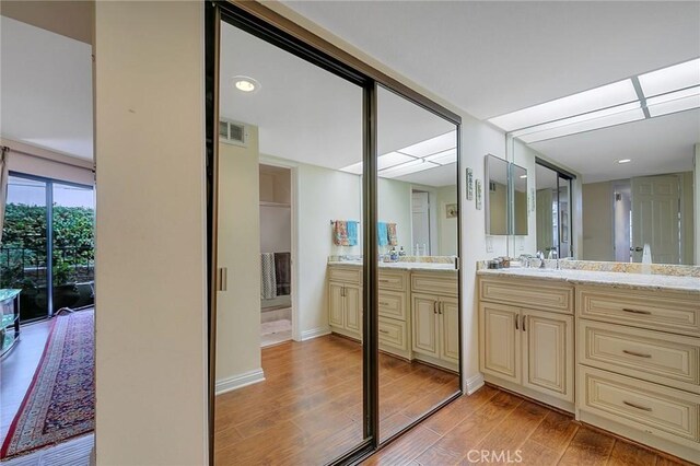 21650 Burbank Blvd Unit 111, Woodland Hills, CA 91367 - full bathroom with baseboards, visible vents, wood finished floors, and vanity
