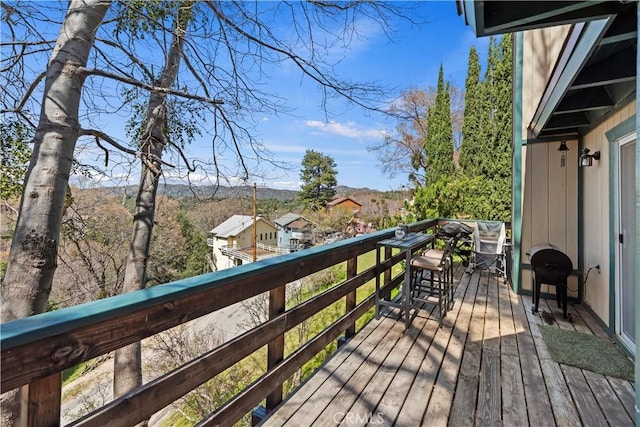 wooden terrace with grilling area and a mountain view