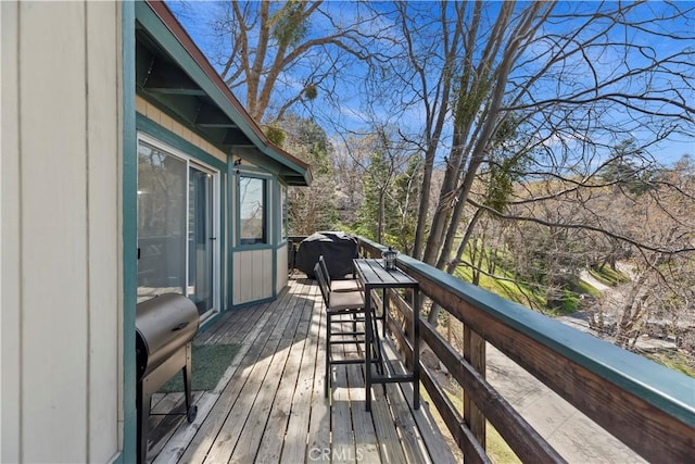 wooden terrace featuring grilling area