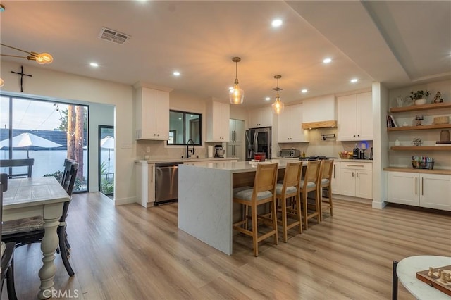 10057 Faywood, Bellflower, CA 90706 - kitchen featuring white cabinetry, visible vents, stainless steel appliances, and light wood-style floors