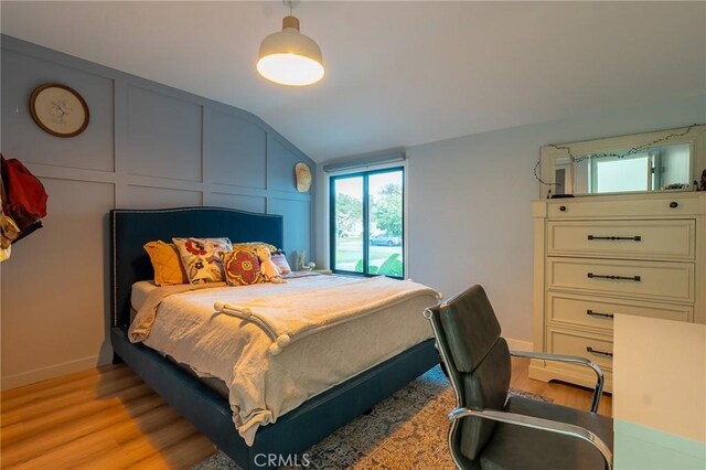 10057 Faywood, Bellflower, CA 90706 - bedroom with a decorative wall, light wood-type flooring, vaulted ceiling, and baseboards