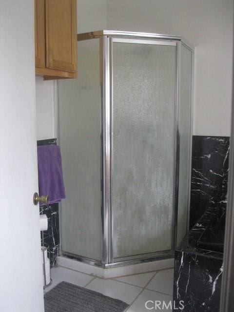 2927 S Genesee Ave, Los Angeles, CA 90016 - bathroom with tile patterned floors and a stall shower