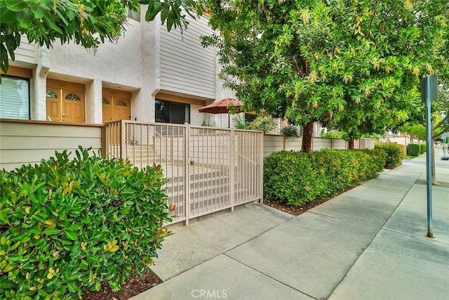 21025 Lemarsh St Unit G39, Chatsworth, CA 91311 - exterior space featuring fence, stucco siding, and a gate