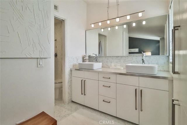 21025 Lemarsh St Unit G39, Chatsworth, CA 91311 - bathroom featuring tasteful backsplash, double vanity, and toilet