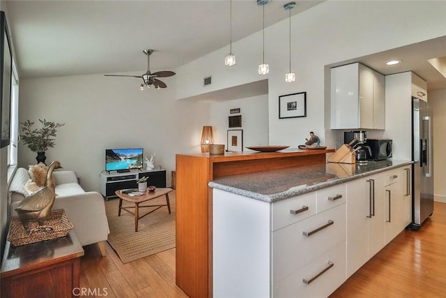 21025 Lemarsh St Unit G39, Chatsworth, CA 91311 - kitchen featuring light wood finished floors, white cabinetry, decorative light fixtures, ceiling fan, and vaulted ceiling