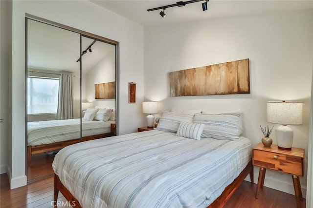 21025 Lemarsh St Unit G39, Chatsworth, CA 91311 - bedroom with track lighting, a closet, dark wood-type flooring, and baseboards