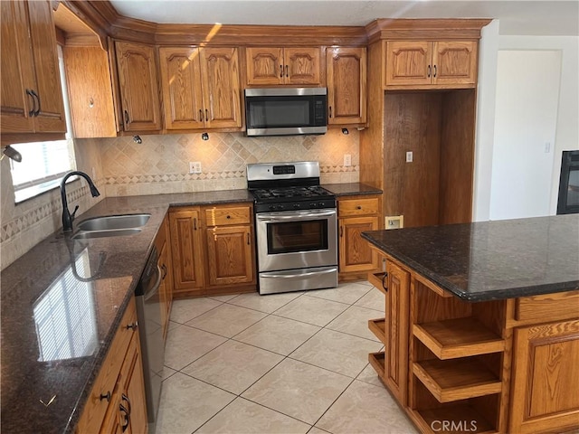 8740 S Loop Blvd, California City, CA 93505 - kitchen with appliances with stainless steel finishes, brown cabinets, tasteful backsplash, and a sink