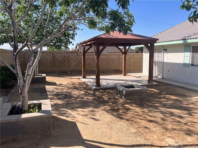 8740 S Loop Blvd, California City, CA 93505 - view of yard featuring a fenced backyard, a gazebo, and a patio