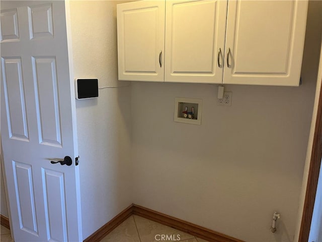 8740 S Loop Blvd, California City, CA 93505 - clothes washing area featuring baseboards, hookup for a washing machine, tile patterned floors, and cabinet space