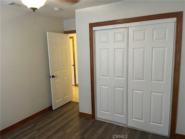 8740 S Loop Blvd, California City, CA 93505 - unfurnished bedroom with a closet, dark wood finished floors, visible vents, and baseboards