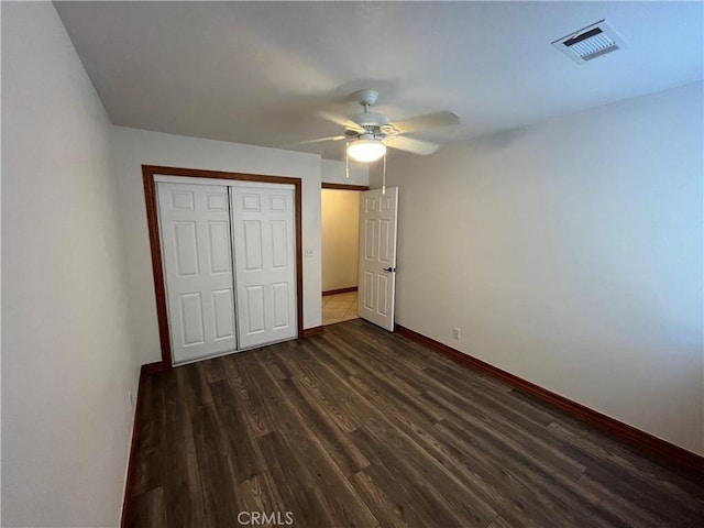 8740 S Loop Blvd, California City, CA 93505 - unfurnished bedroom featuring a closet, wood finished floors, visible vents, a ceiling fan, and baseboards