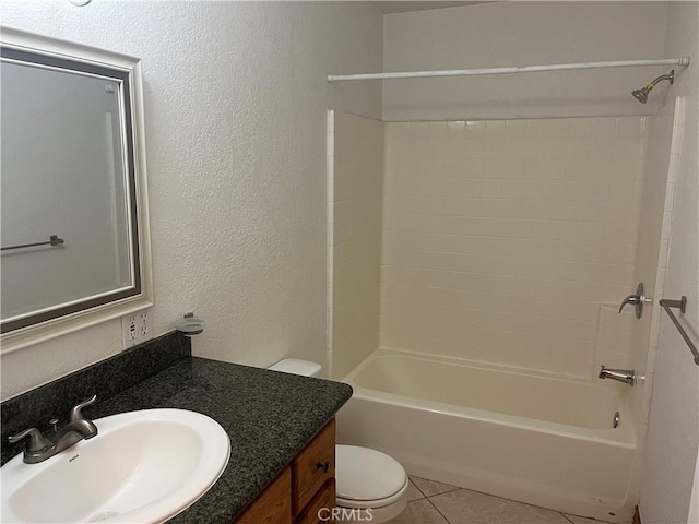 8740 S Loop Blvd, California City, CA 93505 - full bathroom with toilet, bathing tub / shower combination, tile patterned floors, a textured wall, and vanity