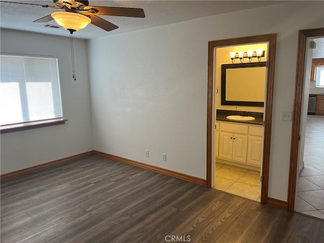 8740 S Loop Blvd, California City, CA 93505 - unfurnished room with a ceiling fan, baseboards, visible vents, and wood finished floors