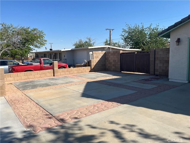 8740 S Loop Blvd, California City, CA 93505 - view of front of home with a gate, fence, and stucco siding