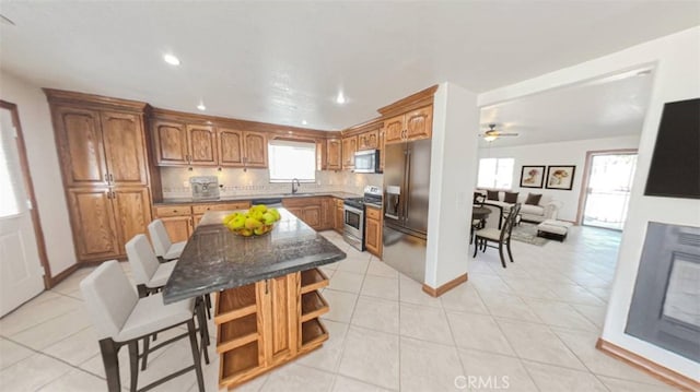 8740 S Loop Blvd, California City, CA 93505 - kitchen featuring a center island, brown cabinets, open shelves, stainless steel appliances, and recessed lighting