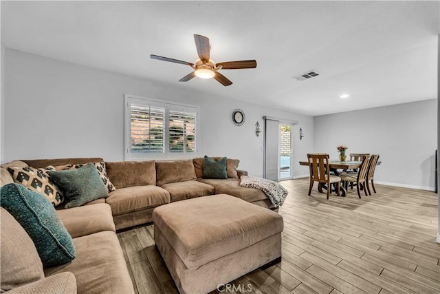 living area featuring recessed lighting, light wood-style floors, ceiling fan, visible vents, and baseboards
