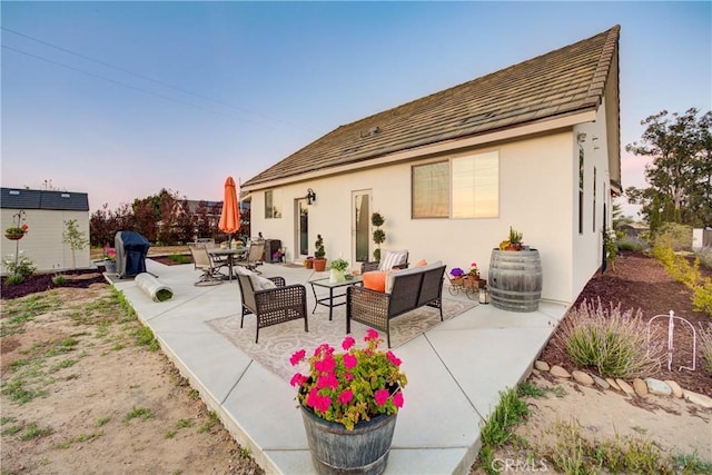 1160 Easy Ln, Nipomo, CA 93444 - back of property at dusk featuring an outdoor hangout area, a patio, and stucco siding